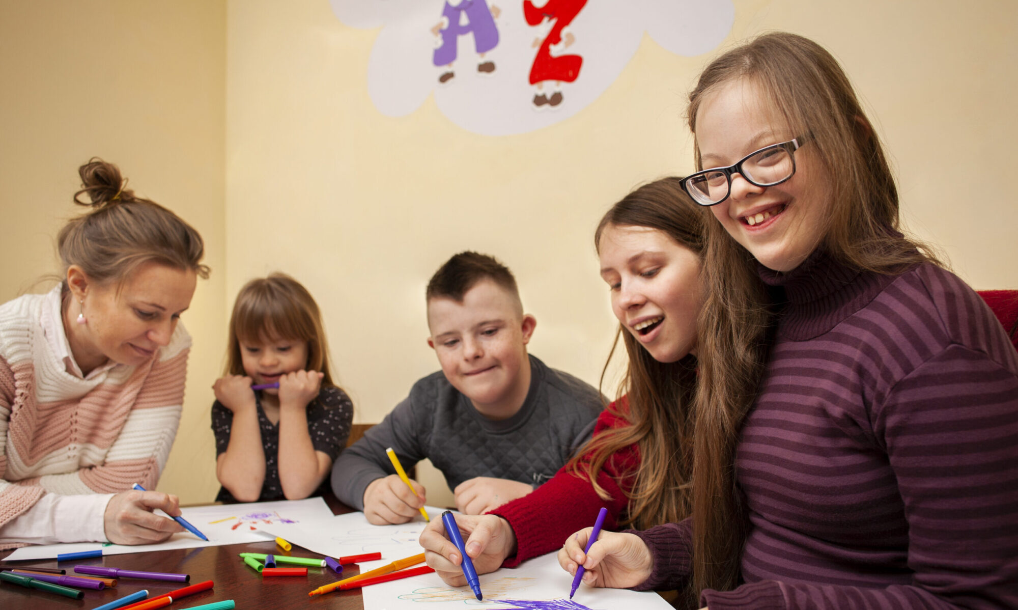 Students drawing with a teacher.